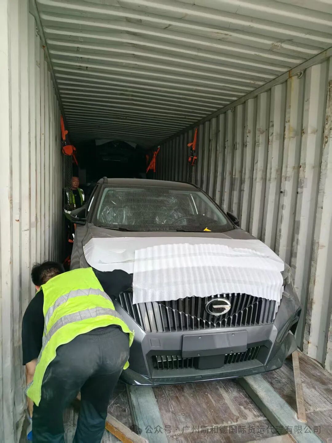 Full view of the third vehicle being loaded into the container using specialized racking